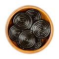 Liquorice wheels, black licorice confection in a wooden bowl Royalty Free Stock Photo