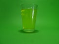 Absinthein a transparent glass on a green background Royalty Free Stock Photo