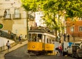 Lisboa, Portugal: a yellow tram climbing the Castle hill Royalty Free Stock Photo