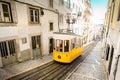 Lisbon city old town narrow streets and tram, Portugal. Famous retro yellow funicular tram on a sunny summer day Royalty Free Stock Photo