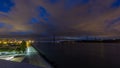 Lisbon city before sunrise with April 25 bridge night to day timelapse Royalty Free Stock Photo