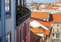 Lisbon cityscape, Portugal. Portuguese buildings with red roofs and balcony with flowers. European architecture. Royalty Free Stock Photo