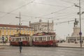 Lisbon - cloudy skies over the yellow square; trams.