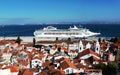 Lisbon harbor with red clay roofs and white cruise ship
