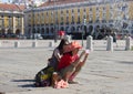 LISBON - JULY 10, 2014: Tourists taking photos on Praca do Comer