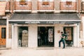 Lisbon, June 18, 2018: Authentic store of art clothes and souvenirs. People inside the store. Nearby on the street there