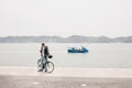 Lisbon, June 18, 2018: A photographer or a young guy or a tourist in casual clothes with a bicycle looks at the camera`s