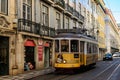 Lisbon morning cityscape with a typical yellow tram on line 28