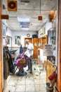 LISBON - OCTOBER 31, 2018: Barber shop with man cutting hairs. S