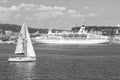 Lisbon, Portugal - April 03, 2010: sailboat and ship on blue sea coast. Sailing boat and ocean liner in sea. Travelling