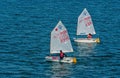 Lisbon, Portugal - April 03, 2010: yachts in blue sea. Children athletes participate in race on sunny day. Sea sailing