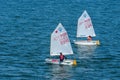 Lisbon, Portugal - April 03, 2010: yachts in blue sea. Children athletes participate in race on sunny day. Sea sailing