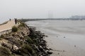 Lisbon Portugal - Areal view of a wave breaker with a pedestrain walk at the Atlantic Coastline with heavy fog Royalty Free Stock Photo