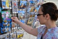 Lisbon, Portugal - 22 august 2018: Girl looking at colorful postcards in Lisbon