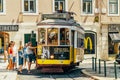 Tourists Travel By Historic Tram In Square of Luis de Camoes Of Downtown Lisbon City