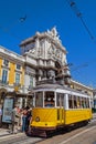 Lisbon, Portugal: Carris vintage yellow tram and Rua Augusta Street Triumphal Arch in Praca do Comercio aka Co Royalty Free Stock Photo