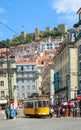 LISBON, PORTUGAL - CIRCA MAY 2014 - Old portuguese traditional electric yellow tram makes its way across central Lisbon streets