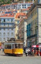 LISBON, PORTUGAL - CIRCA MAY 2014 - Old portuguese traditional electric yellow tram makes its way across central Lisbon streets