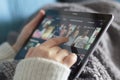 Woman choosing a netflix movie on tablet Royalty Free Stock Photo