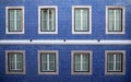 Detail of the facade of a building with blue tiles and window