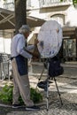 Lisbon, Portugal. 10.05.2023 Elderly artist painting on the street in the center of Lisbon