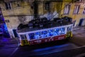 Famous yellow tram 28 driving along Lisbon`s old street. Neon light inside tram. Lisbon, Portugal - 22.08.2019 Royalty Free Stock Photo