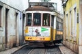 Famous tram cable car 28 makes its way up the narrow cobblestone streets of Lisbon