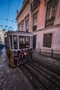 Lisbon, Portugal, January 25, 2020: Glory elevator tram full of graffiti on rails on a steep hill viewed from the front