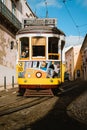 LISBON, PORTUGAL - January 01, 2018: Iconic yellow tram Line 28 in Lisbon, Portugal. Lisbon`s tram driving down narrow Royalty Free Stock Photo