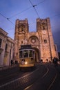 Lisbon, Portugal, January 24, 2020: SE cathedral with old yellow tram passing by at blue hour Royalty Free Stock Photo