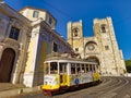 Lisbon, Portugal - July 2022: The Lisbon Cathedral with a traditional yellow tram in Lisbon, Portugal Royalty Free Stock Photo