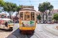 Lisbon, Portugal - July 15, 2019: The famous yellow tram 28 passing in front of Santa Maria cathedral in Lisbon, Portugal Royalty Free Stock Photo