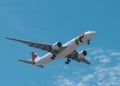 View of a TAP Air Portugal Airbus A321 jet airplane approaching to land with blue sky background