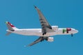 View of a TAP Air Portugal Airbus A321 jet airplane approaching to land with blue sky background