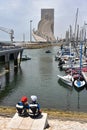 2 Young sailors look across to the Monument to the Discoveries in Belem Harbour. Lisbon, Portugal