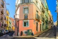 Crossroads of typical narrow streets with colorful multicolored traditional buildings and houses in Lisboa historical city centre