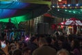 Crowd of people dancing on street on popular saints festival