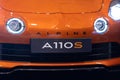 11-17-2022 LISBON, PORTUGAL - Lisboa Games Week 17 - Orange sports car stands with headlights on the track - Alpine