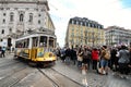 Colorful yellow trams at the Camoes Square in Lisbon