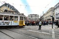 Colorful yellow trams at the Camoes Square in Lisbon