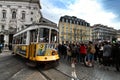 Colorful yellow trams at the Camoes Square in Lisbon