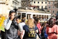 Colorful yellow trams at the Camoes Square in Lisbon