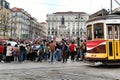 Colorful yellow trams at the Camoes Square in Lisbon