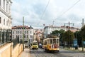 Iconic, yellow tram 28 in Lisbon, Portugal. View of street with buildings in the distance Royalty Free Stock Photo
