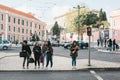 Lisbon, Portugal 01 may 2018: Pedestrians cross street. Girls or company of friends stand on intersection.