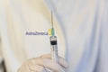 Medic ,scientist, pharmacist holding Syringe with AstraZeneca logo on lab coat. Coronavirus, Covid-19 vaccine concept Royalty Free Stock Photo