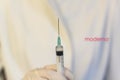 Medic ,scientist, pharmacist holding Syringe with Moderna logo on lab coat. Coronavirus, Covid-19 vaccine concept Royalty Free Stock Photo