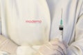 Medic ,scientist, pharmacist holding Syringe with Moderna logo on lab coat. Coronavirus, Covid-19 vaccine concept Royalty Free Stock Photo