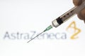 Syringe and AstraZeneca logo on the background. Coronavirus, Covid-19 vaccine concept Royalty Free Stock Photo