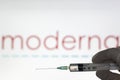 Syringe and Moderna logo on the background. Coronavirus, Covid-19 vaccine concept Royalty Free Stock Photo